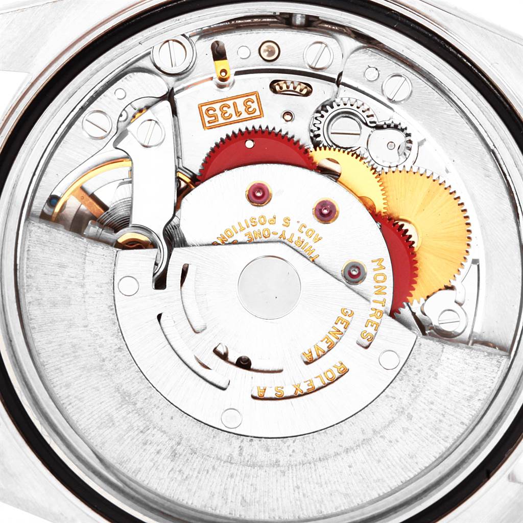 The image shows an internal close-up of the movement mechanism of a Rolex Datejust 16234 Men's Stainless Steel Mother of Pearl Dial 16234 Men's Stainless Steel Mother of Pearl Dial watch, highlighting gears and components.