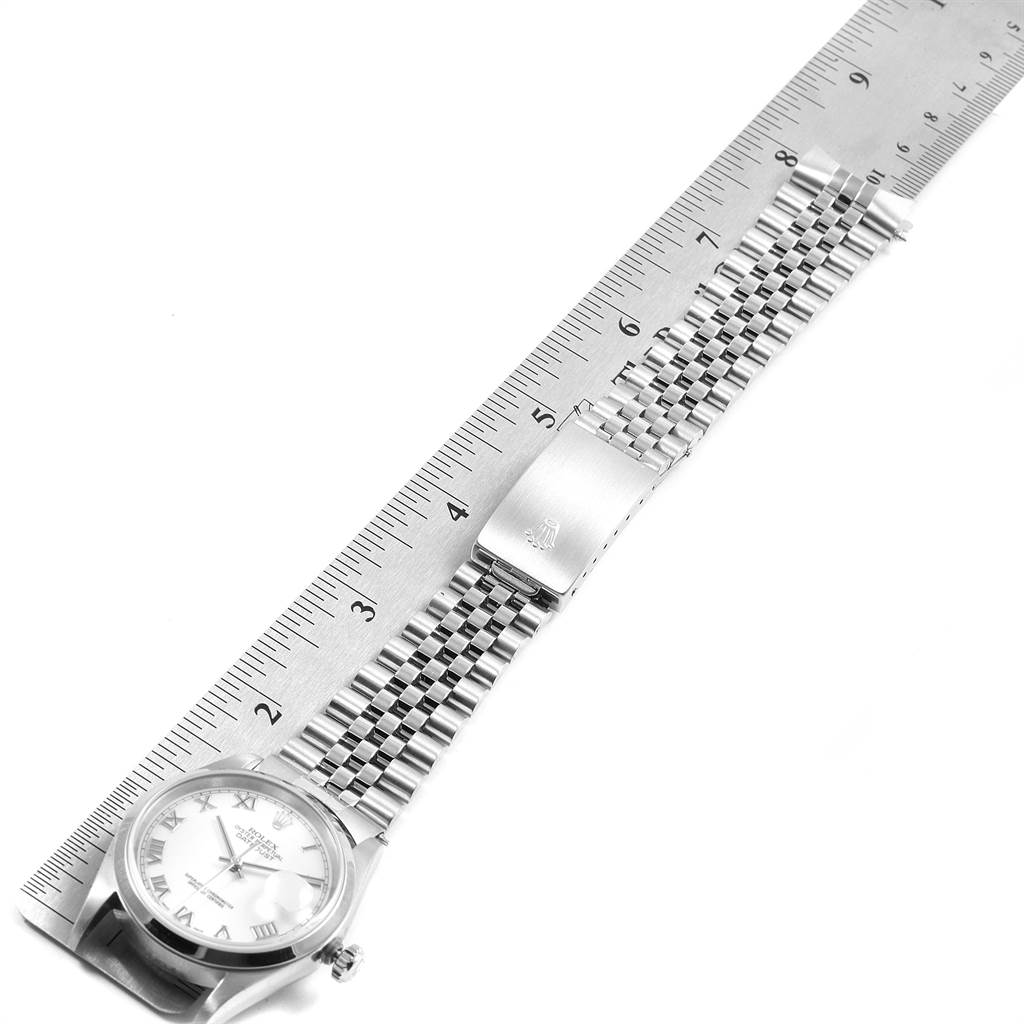 The image shows a top-down view of a Rolex Datejust 16200 Men's Stainless Steel White Dial 16200 Men's Stainless Steel White Dial watch with its bracelet facing upward, aligned next to a ruler for measurement.