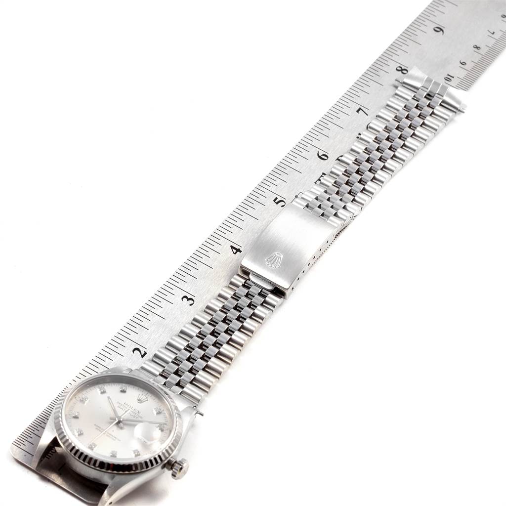 The image shows a flat-lay view of a Rolex Datejust 16234 Men
s Stainless Steel Silver Dial 16234 Men
s Stainless Steel Silver Dial watch, including the face, bracelet, and clasp, measured against a ruler.