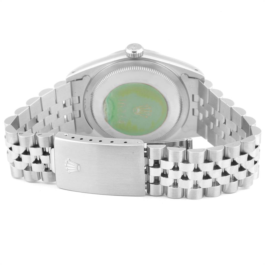 The image shows the back of a Rolex Datejust 16234 Men
s Stainless Steel Silver Dial 16234 Men
s Stainless Steel Silver Dial watch, focusing on its case back and metal bracelet clasp.