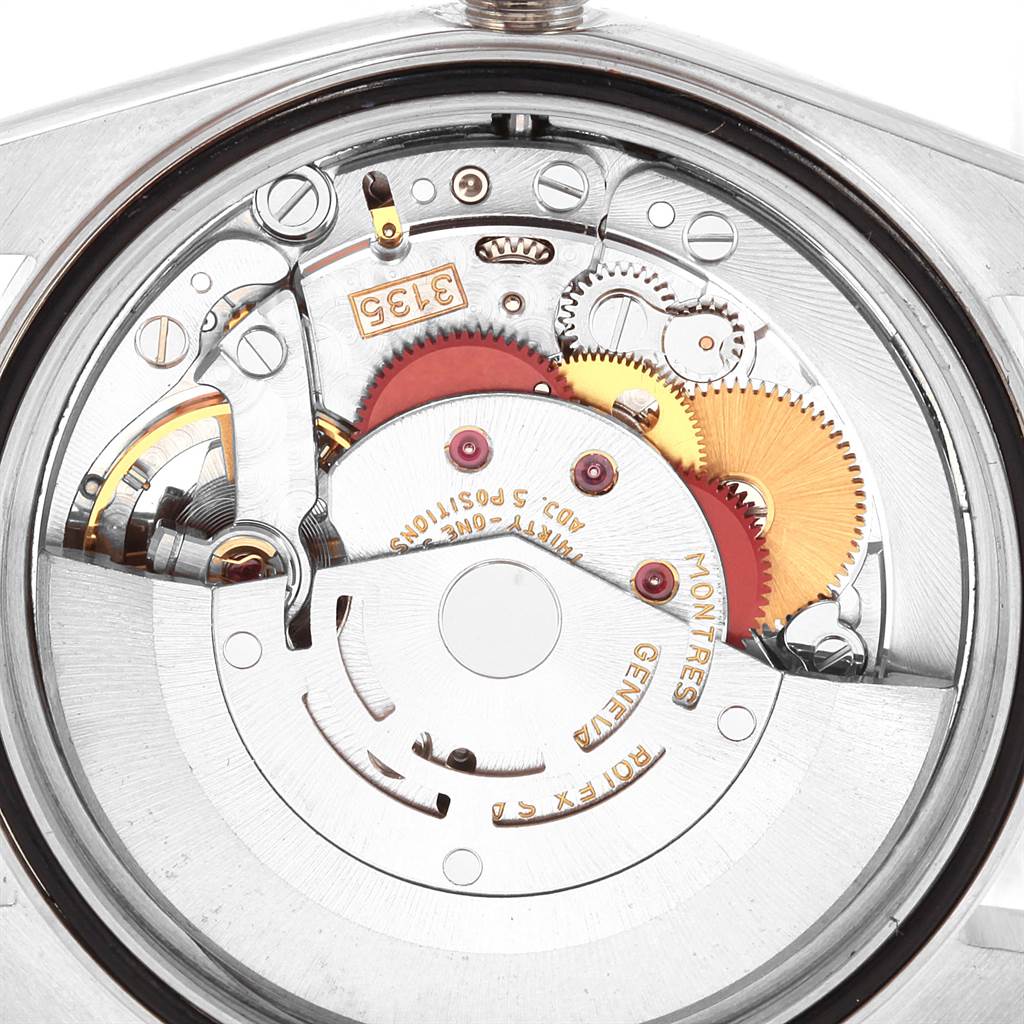 The image shows a close-up of the internal mechanism of a Rolex Datejust 16234 Men
s Stainless Steel Silver Dial 16234 Men
s Stainless Steel Silver Dial watch, highlighting the gears and inscriptions.