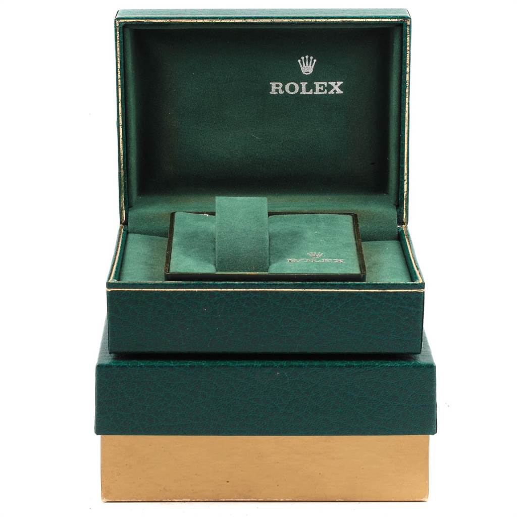 The image shows an open green and gold Rolex box for the Datejust model, displaying the watch cushion inside.