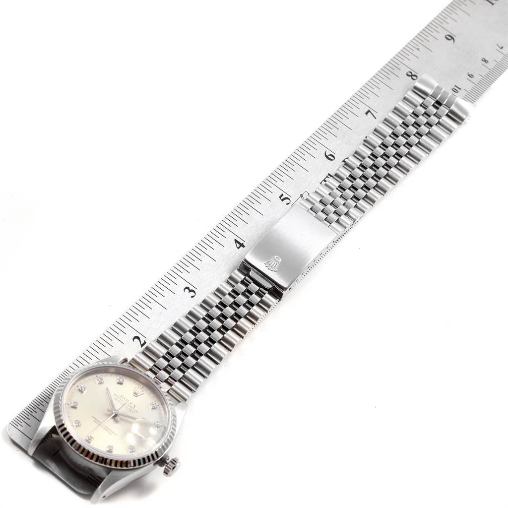 The image shows a Rolex Datejust 16234 Men's Stainless Steel Silver Dial 16234 Men's Stainless Steel Silver Dial watch laid flat with a ruler, displaying the face, bracelet, and clasp.