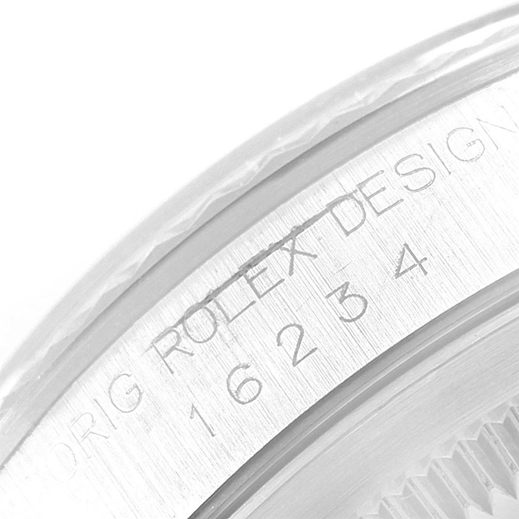 This close-up image shows the engraved serial number and the case design details of a Rolex Datejust 16234 Men's Stainless Steel Silver Dial 16234 Men's Stainless Steel Silver Dial watch.