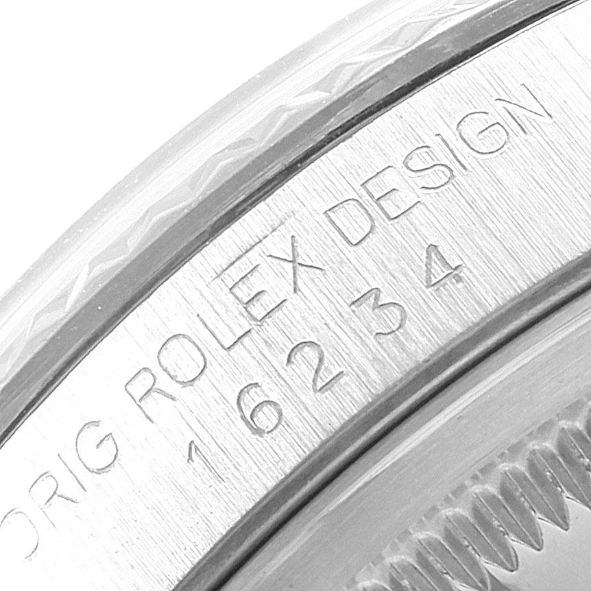 The image shows a close-up of the engraved bezel and the serial number on a Rolex Datejust 16234 Men's Stainless Steel Grey Dial 16234 Men's Stainless Steel Grey Dial watch. 