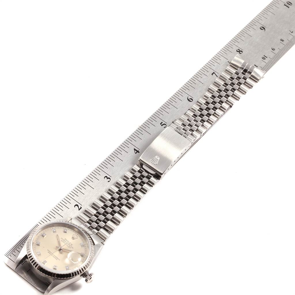 The image shows a Rolex Datejust 16234 Men's Stainless Steel Silver Dial 16234 Men's Stainless Steel Silver Dial watch laid flat with its face, metal bracelet, and clasp visible, placed next to a ruler.