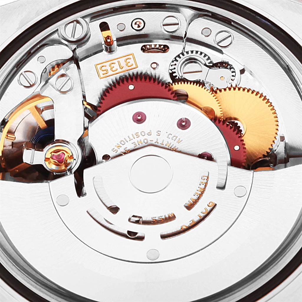 This image shows a close-up of the internal mechanical movement of a Rolex Datejust 116231 Men's Steel and Gold (two tone) Pink Dial 116231 Men's Steel and Gold (two tone) Pink Dial watch, highlighting its gears and components.