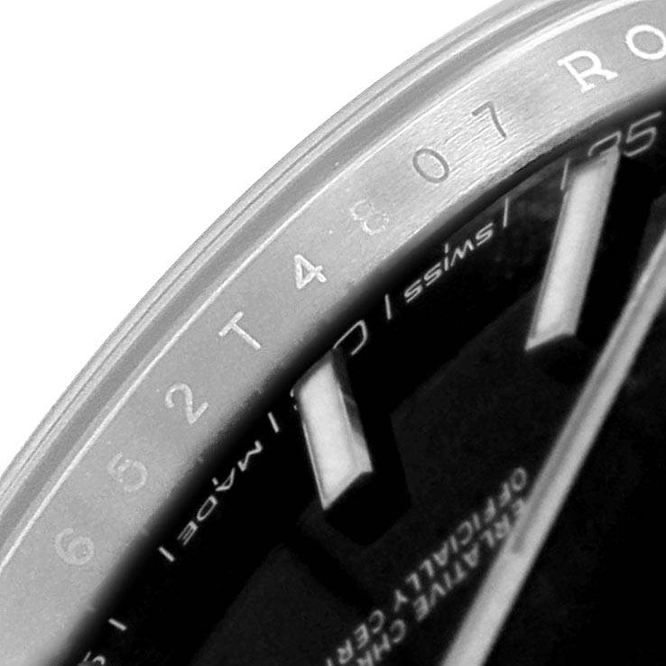 This close-up shows part of the dial, markers, and text on a Rolex Datejust 126300 Men
s Stainless Steel Black Dial 126300 Men
s Stainless Steel Black Dial watch, viewed at an angular perspective.