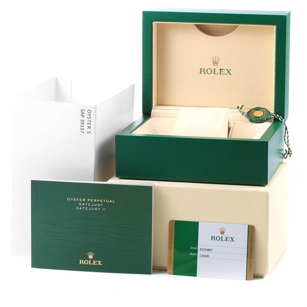 The image shows the packaging and accessories of a Rolex Datejust 126300 Men
s Stainless Steel Black Dial 126300 Men
s Stainless Steel Black Dial model, including the box, booklet, and warranty card.