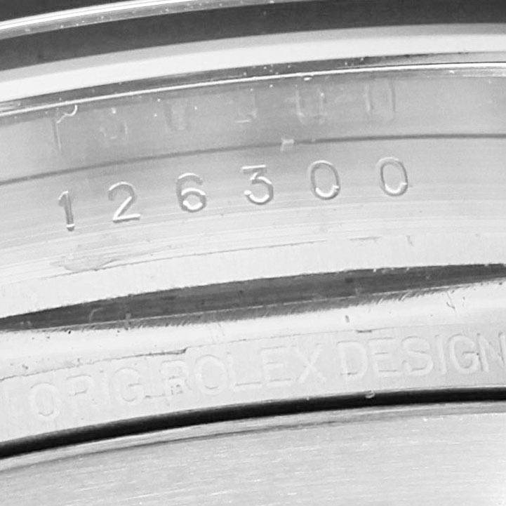 This image shows a close-up of the inner case with model numbers of a Rolex Datejust 126300 Men
s Stainless Steel Blue Dial 126300 Men
s Stainless Steel Blue Dial watch.
