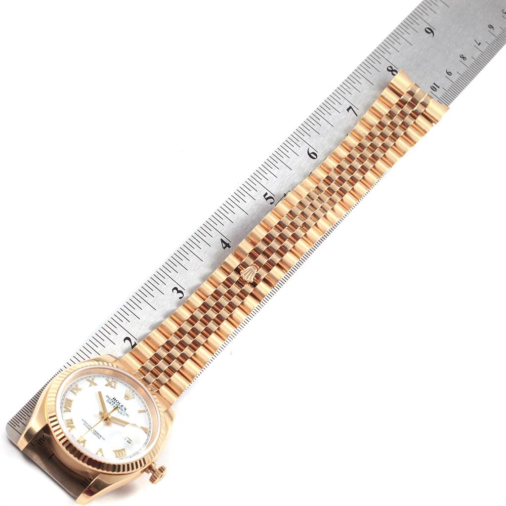 The image shows a Rolex Datejust 116238 Men's Yellow Gold White Dial 116238 Men's Yellow Gold White Dial watch at an angle from the side with its golden bracelet extended next to a ruler for measurement.
