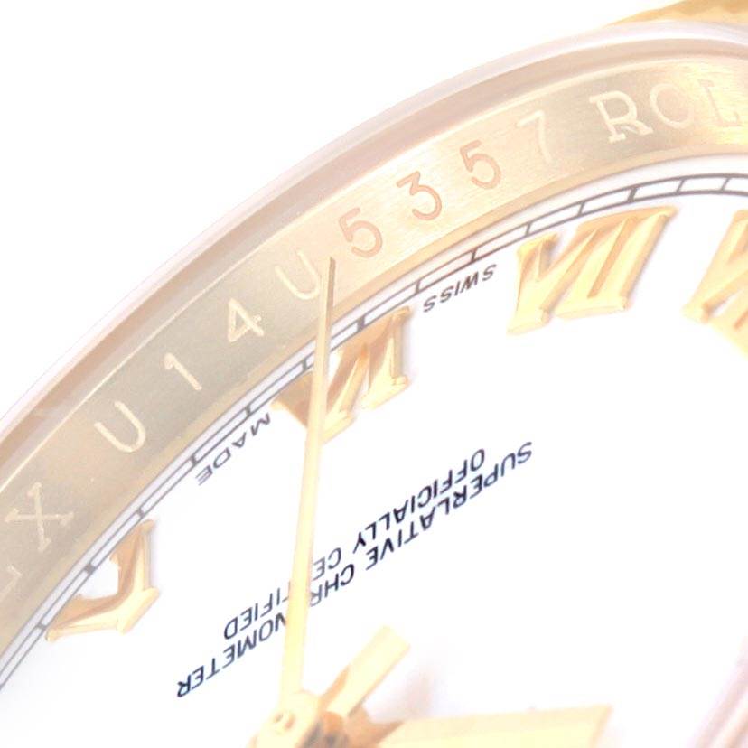 The image shows a close-up of the Rolex Datejust 116238 Men's Yellow Gold White Dial 116238 Men's Yellow Gold White Dial watch dial, showcasing its Roman numerals and part of the bezel.