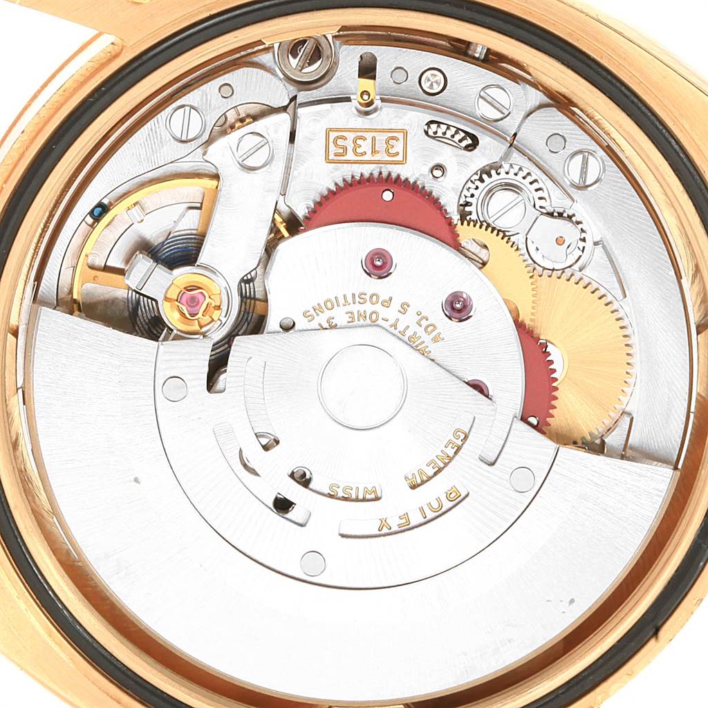 Close-up view of the Rolex Datejust 116238 Men's Yellow Gold White Dial 116238 Men's Yellow Gold White Dial movement and inner mechanism parts.