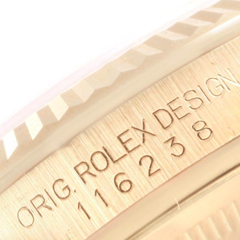 The image shows a close-up of the bezel and engraved serial number of a Rolex Datejust 116238 Men's Yellow Gold White Dial 116238 Men's Yellow Gold White Dial model.