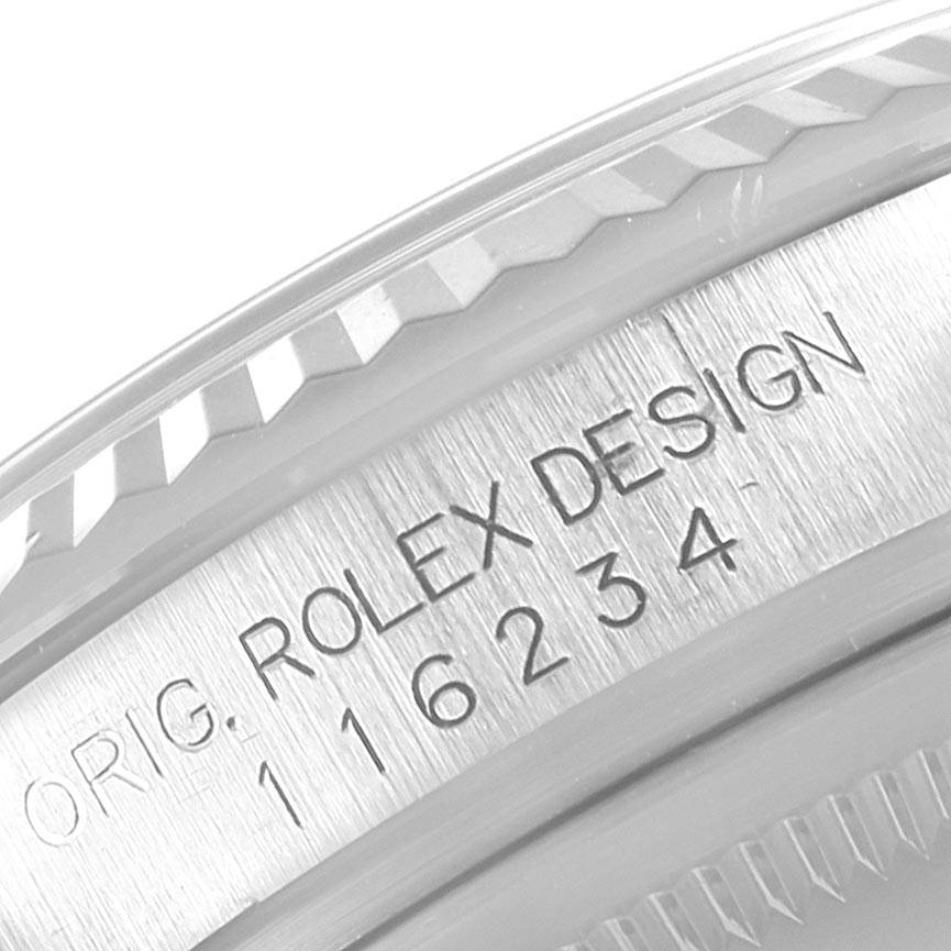 This image shows a close-up of the bezel and engraved serial number on a Rolex Datejust 116234 Men's Stainless Steel Black Dial 116234 Men's Stainless Steel Black Dial watch.