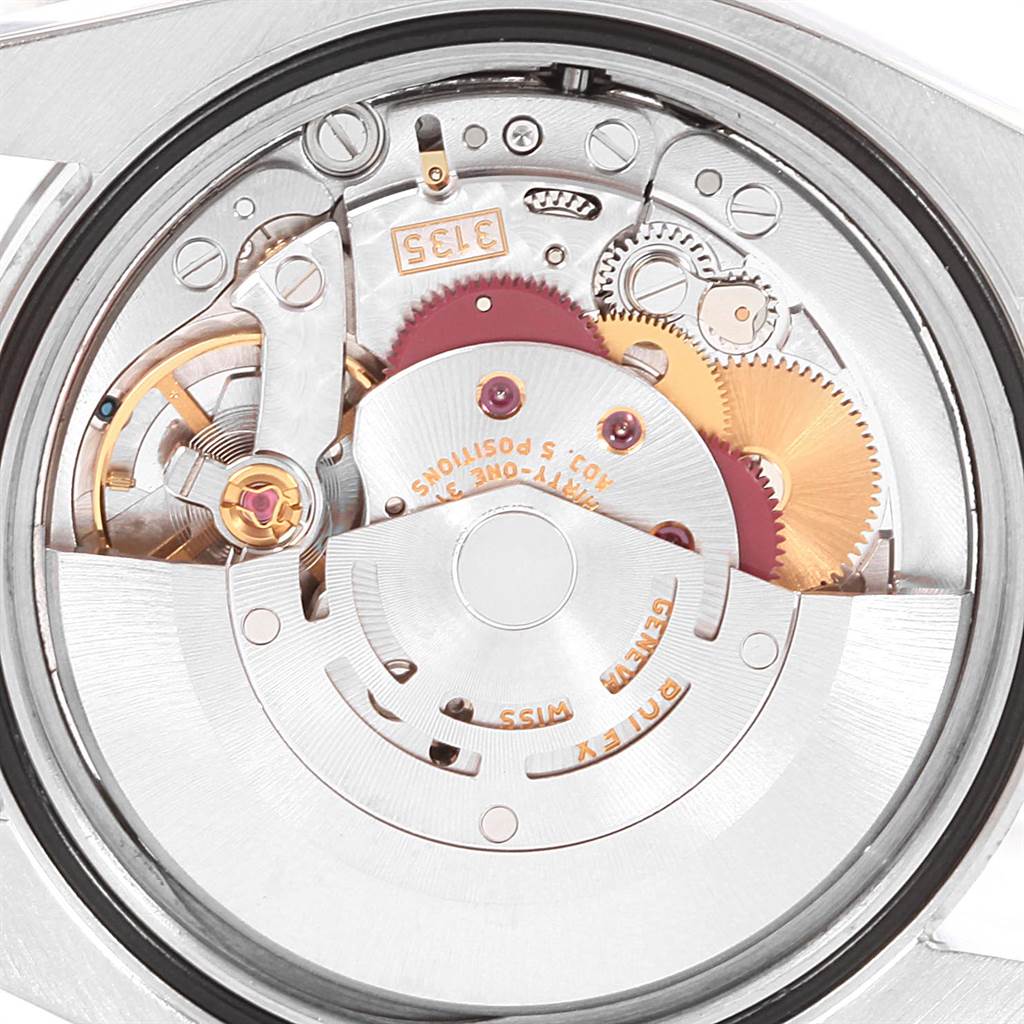 This is a close-up view of the movement mechanism of a Rolex Datejust 116234 Men's Stainless Steel Black Dial 116234 Men's Stainless Steel Black Dial watch, showing gears, cogs, and the rotor.