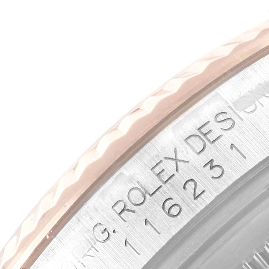 This image shows a close-up angle of the bezel and part of the engraved rehaut of a Rolex Datejust 116231 Men's Steel and Gold (two tone) Black Dial 116231 Men's Steel and Gold (two tone) Black Dial watch.