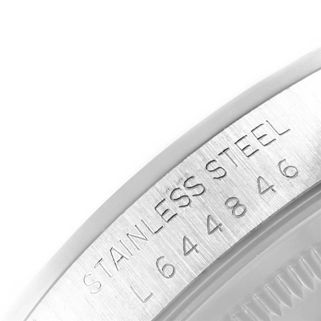 The image shows a close-up of the case back of a Rolex Datejust 16200 Men's Stainless Steel White Dial 16200 Men's Stainless Steel White Dial, focusing on the engraved serial number and "Stainless Steel" marking.