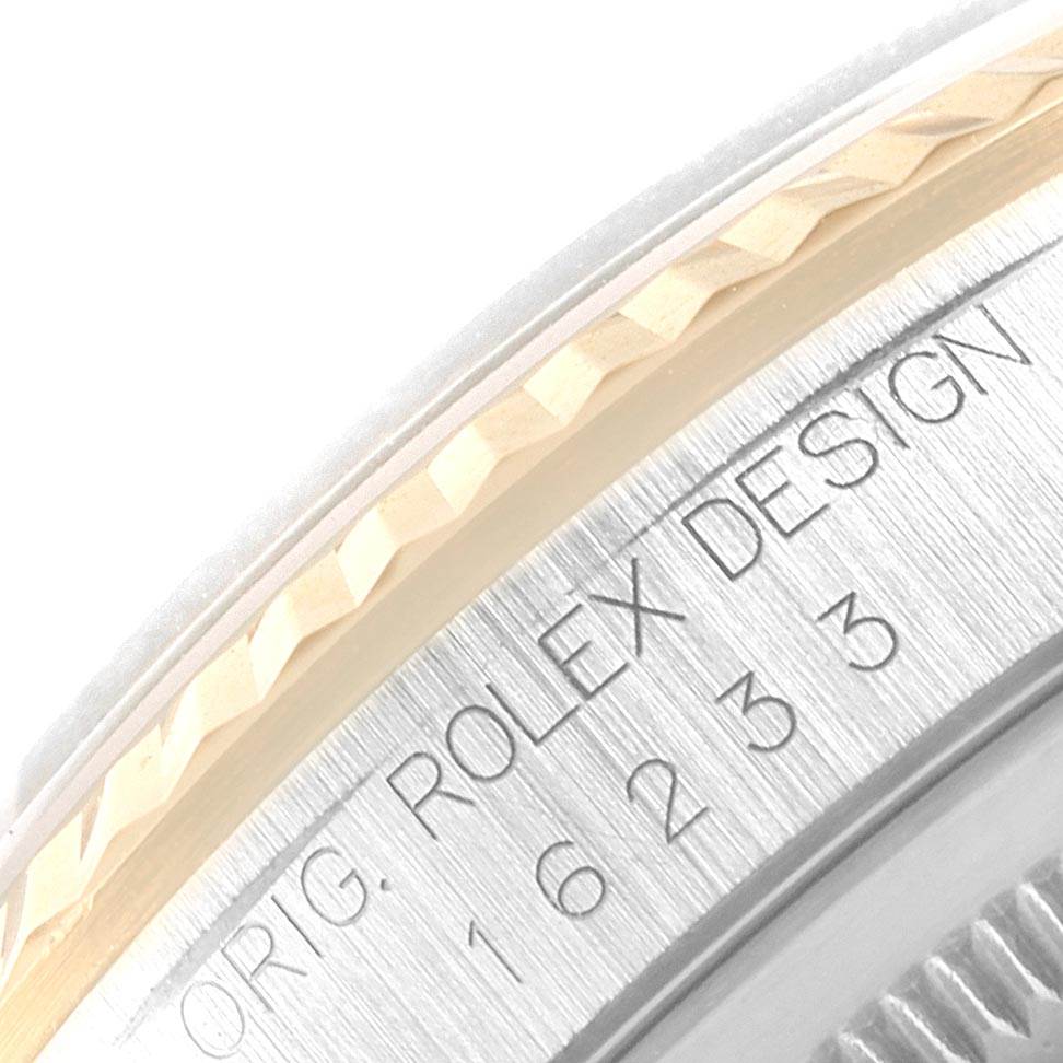 This image shows a close-up of the bezel and engraved side of a Rolex Datejust 16233 Men's Steel and Gold (two tone) Blue Dial 16233 Men's Steel and Gold (two tone) Blue Dial watch case.
