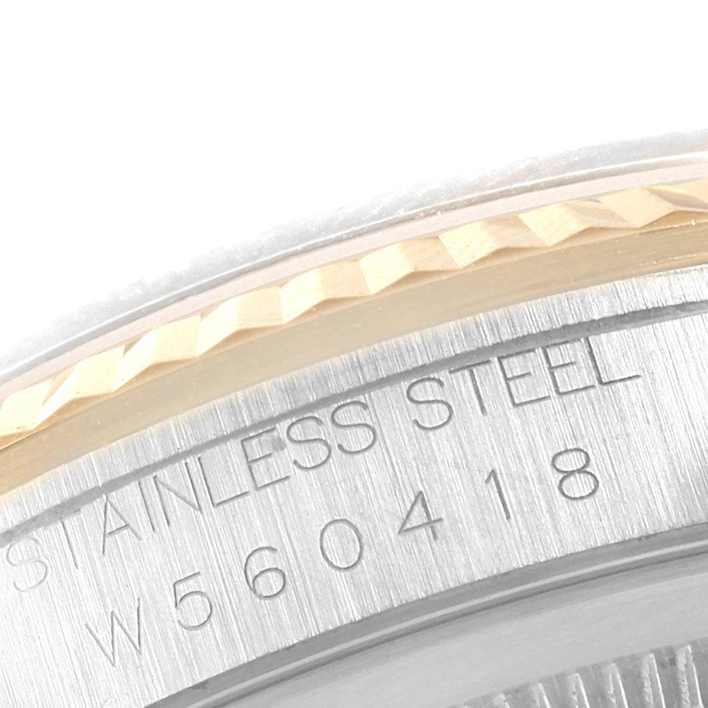 This close-up image shows the stainless steel case back and part of the fluted bezel of the Rolex Datejust 16233 Men's Steel and Gold (two tone) Blue Dial 16233 Men's Steel and Gold (two tone) Blue Dial watch.