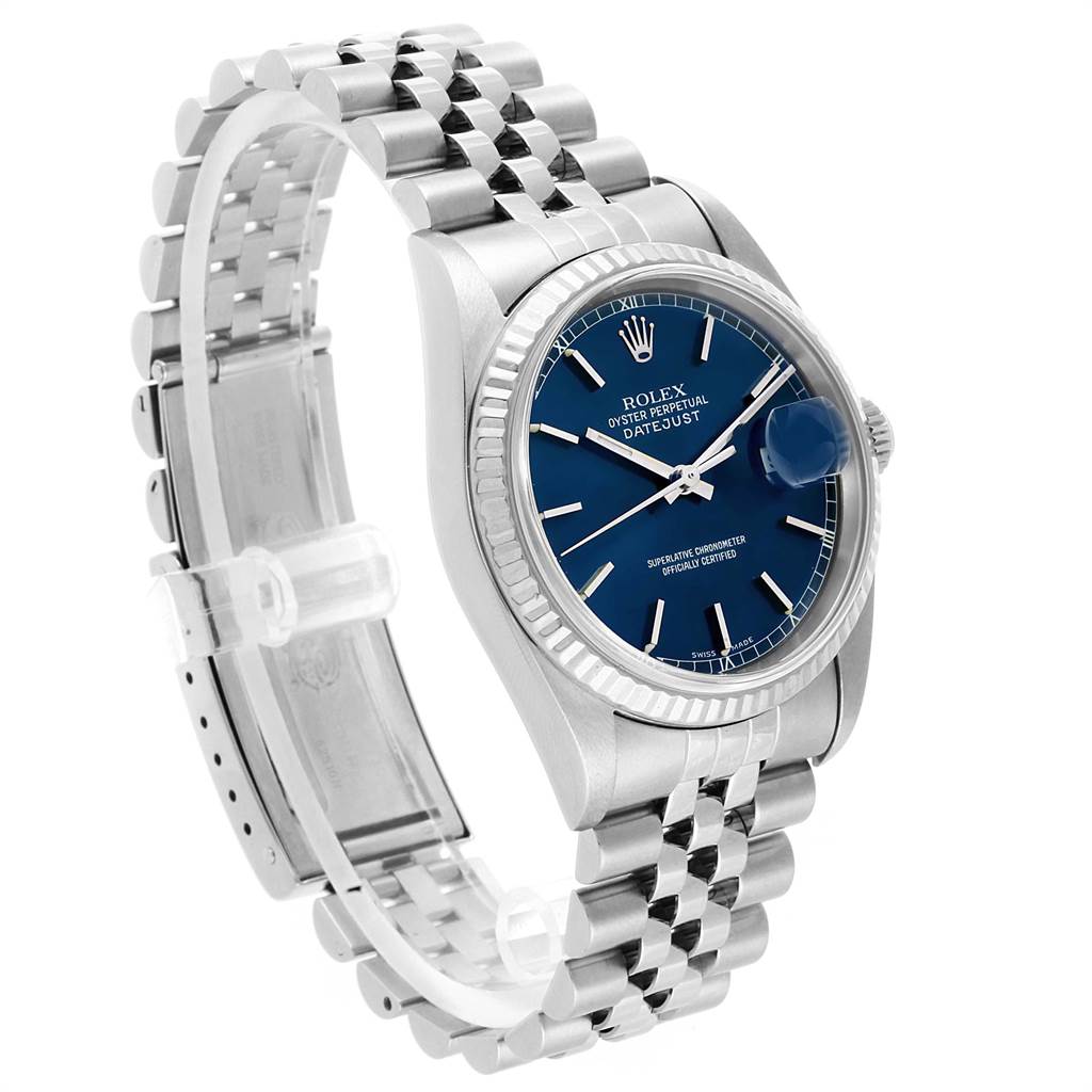 The image shows a Rolex Datejust 16234 Men
s Stainless Steel Blue Dial 16234 Men
s Stainless Steel Blue Dial watch at a slight angle displaying its blue dial, fluted bezel, and Jubilee bracelet.