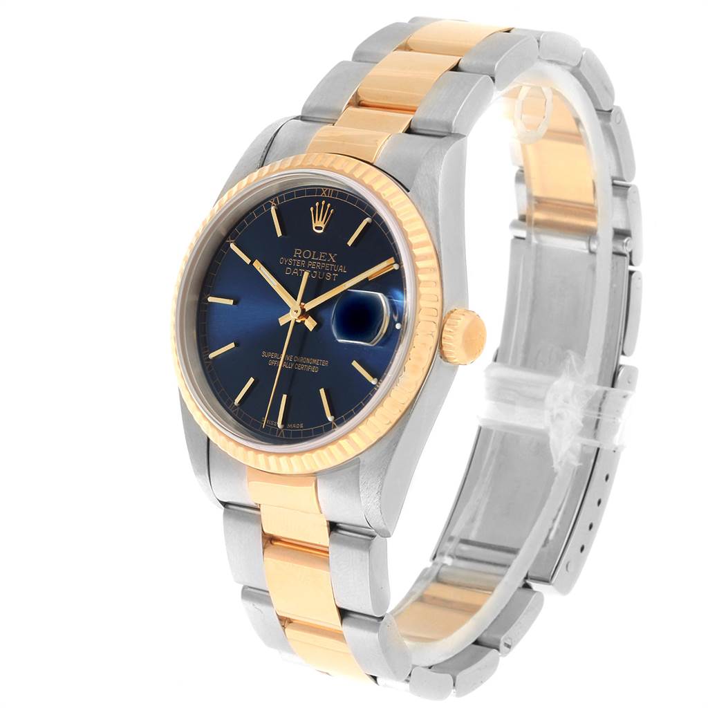 This image shows a Rolex Datejust 16233 Men's Steel and Gold (two tone) Blue Dial 16233 Men's Steel and Gold (two tone) Blue Dial watch at a three-quarter angle, highlighting its blue dial, gold fluted bezel, and two-tone bracelet.