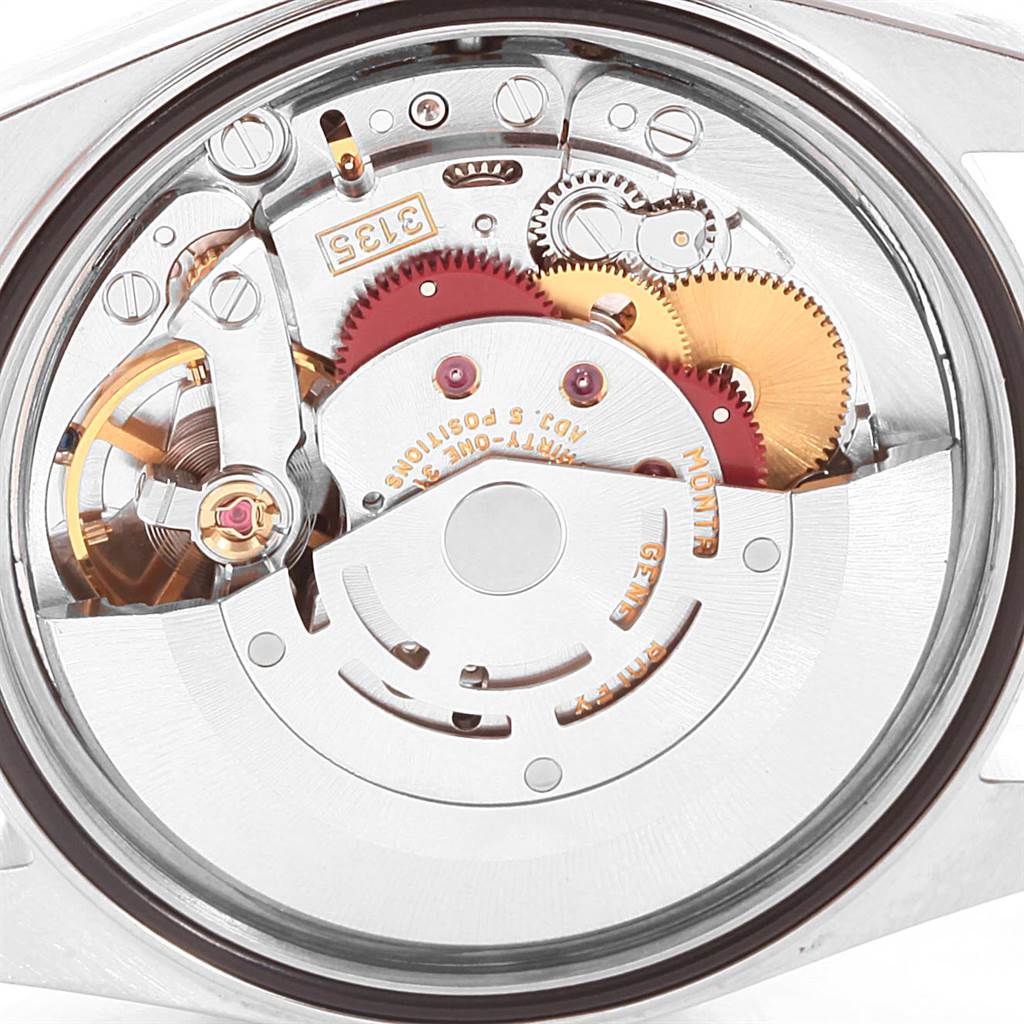 The image shows a close-up view of the movement inside a Rolex Datejust 16233 Men's Steel and Gold (two tone) Blue Dial 16233 Men's Steel and Gold (two tone) Blue Dial watch, highlighting gears and intricate mechanisms.