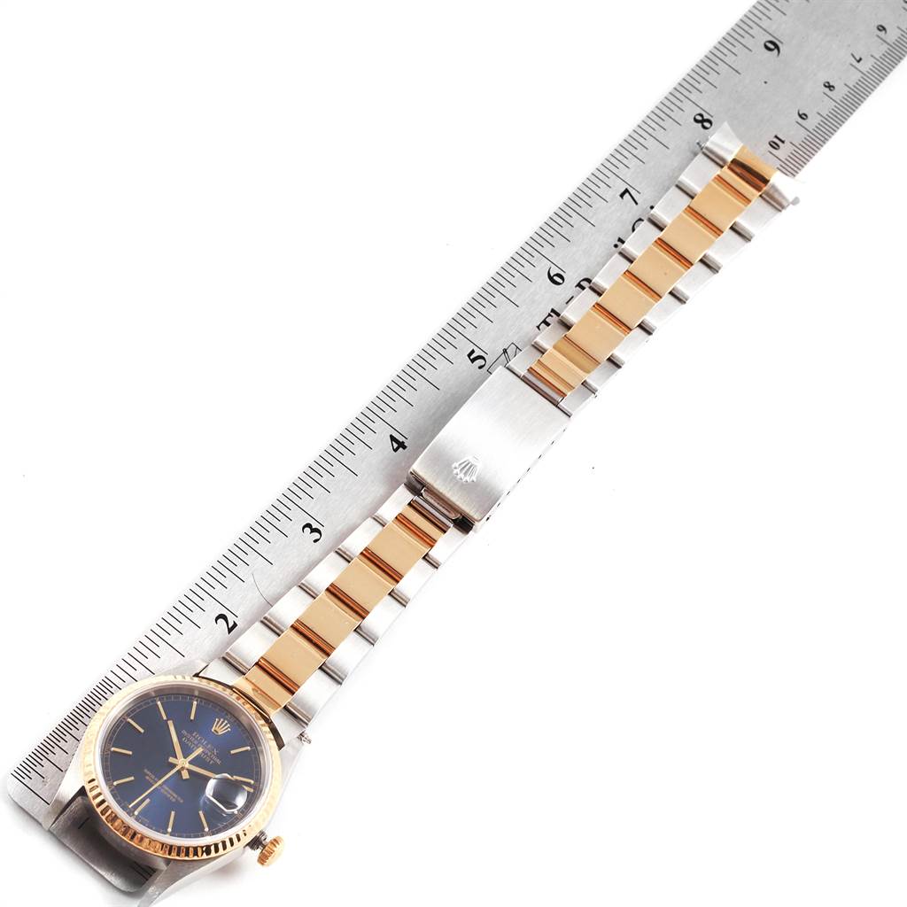 The Rolex Datejust 16233 Men's Steel and Gold (two tone) Blue Dial 16233 Men's Steel and Gold (two tone) Blue Dial watch is shown from an overhead angle, displaying its face, bracelet, and clasp.