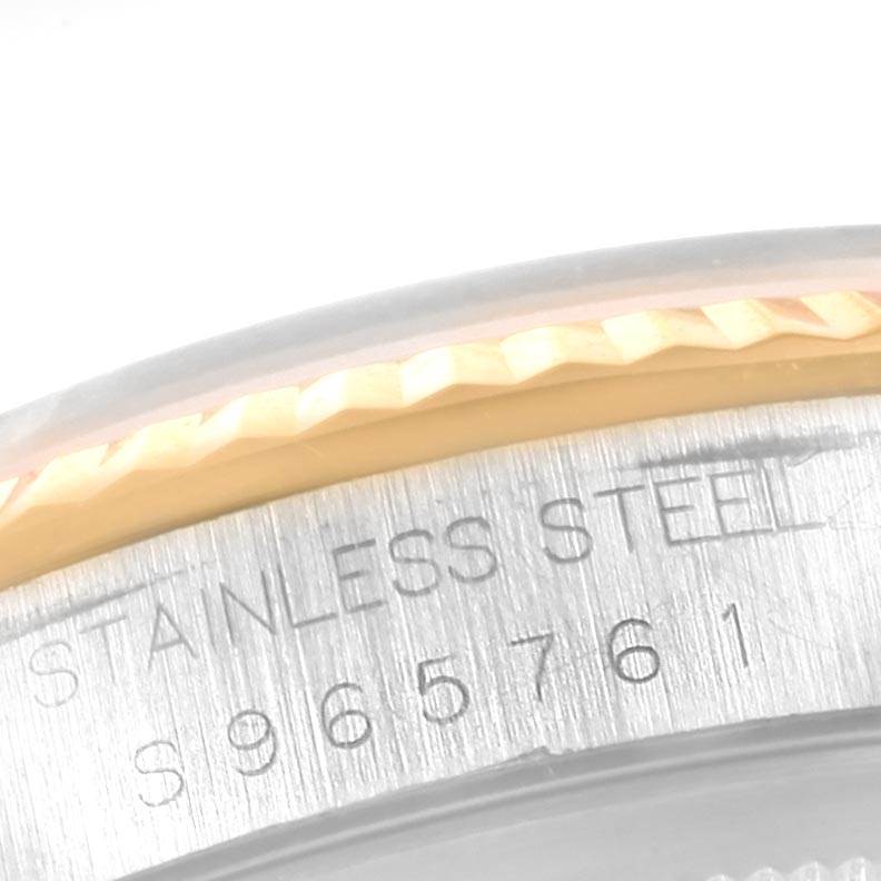 This close-up image shows the bezel and the stainless steel casing with engraved serial number of a Rolex Datejust 16233 Men
s Steel and Gold (two tone) Blue Dial 16233 Men
s Steel and Gold (two tone) Blue Dial watch.