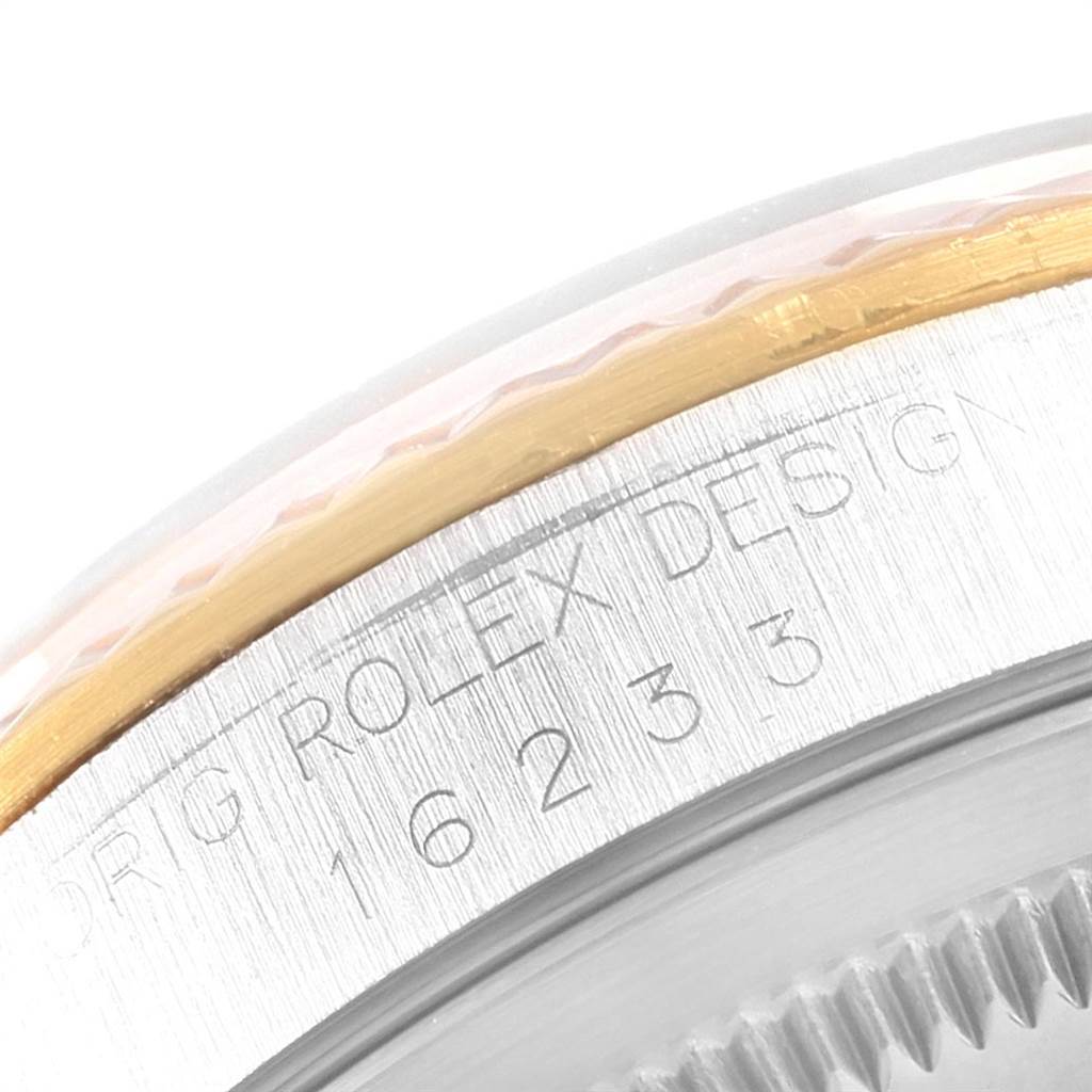 This close-up image shows the outer rim, bezel, and part of the engraved serial number on a Rolex Datejust 16233 Men
s Steel and Gold (two tone) Blue Dial 16233 Men
s Steel and Gold (two tone) Blue Dial watch.