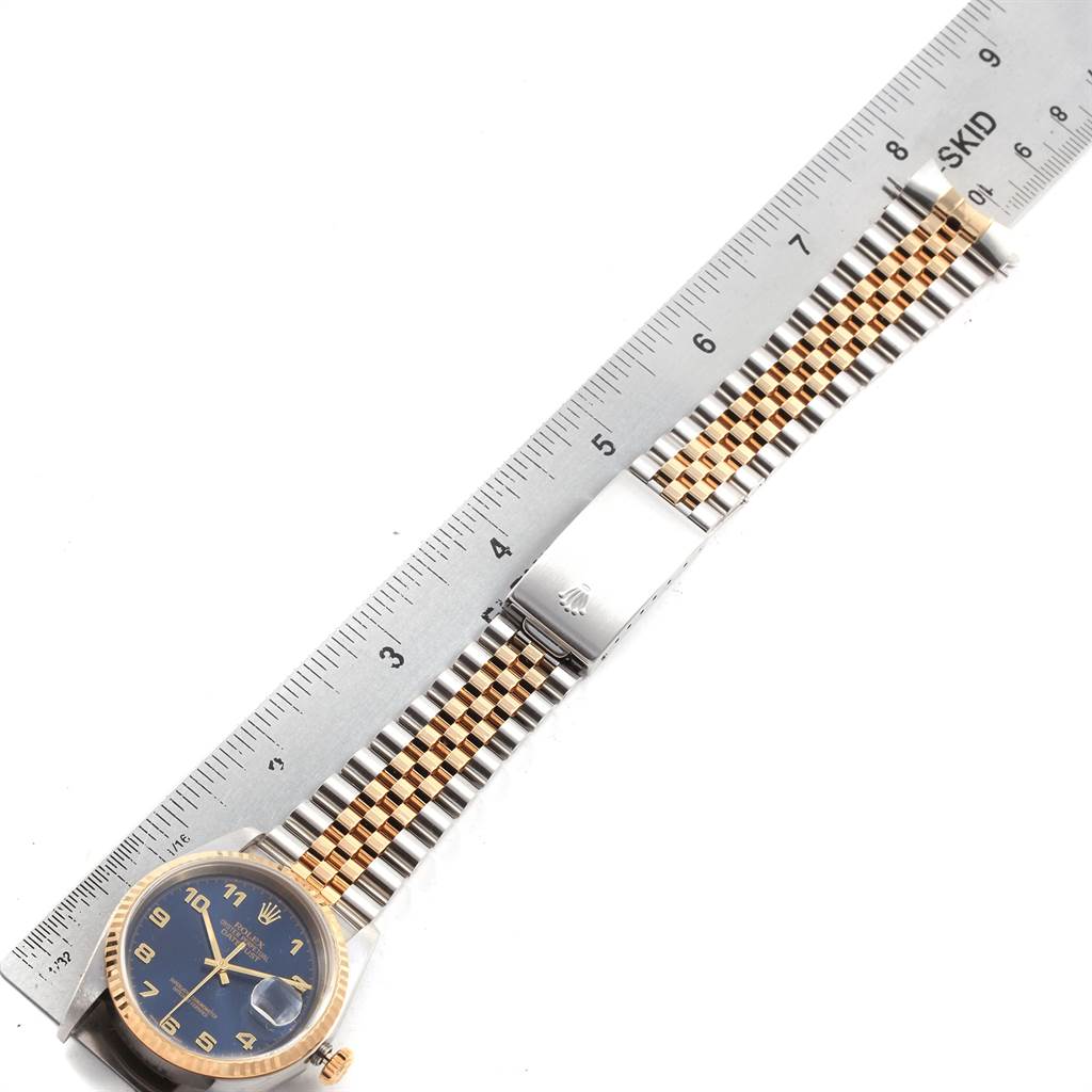 The image shows a Rolex Datejust 16233 Men's Steel and Gold (two tone) Blue Dial 16233 Men's Steel and Gold (two tone) Blue Dial watch lying flat, with its band extended beside a ruler for measurement.