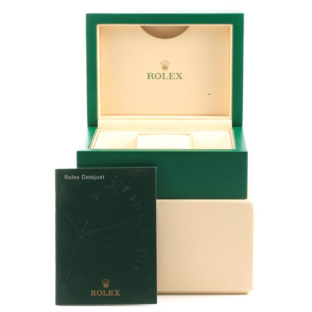 The image shows the inside of a green Rolex Datejust 116243 Men's Stainless Steel Black Dial 116243 Men's Stainless Steel Black Dial watch box along with its manual placed in front.