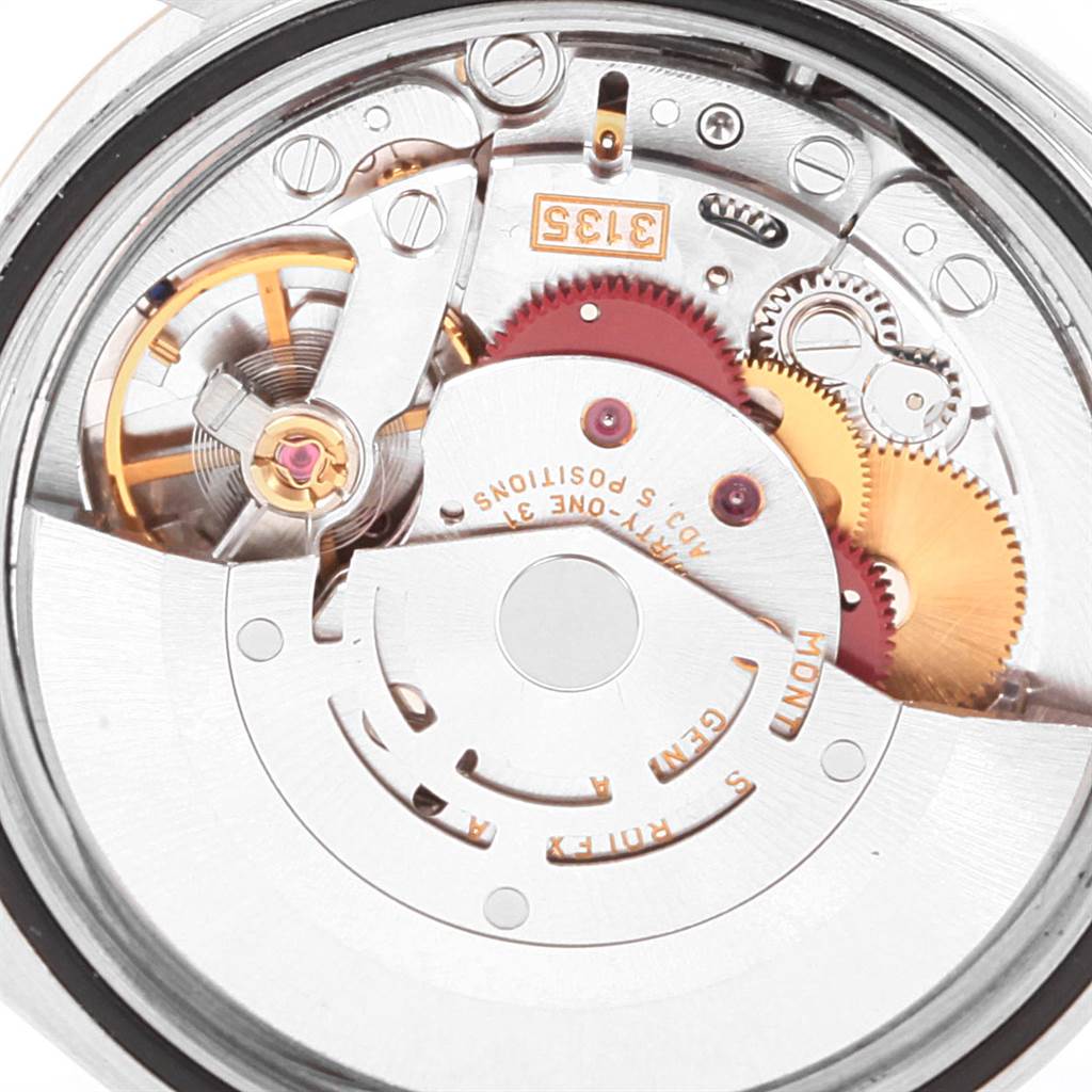 This image shows a close-up of the movement mechanism of a Rolex Datejust 16233 Men's Steel and Gold (two tone) White Dial 16233 Men's Steel and Gold (two tone) White Dial watch, highlighting gears and intricate internal components.
