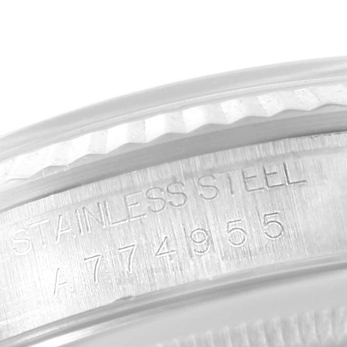 The image shows a close-up of the side case of a Rolex Datejust 16234 Men's Stainless Steel Silver Dial 16234 Men's Stainless Steel Silver Dial watch, highlighting the serial number and stainless steel engraving.