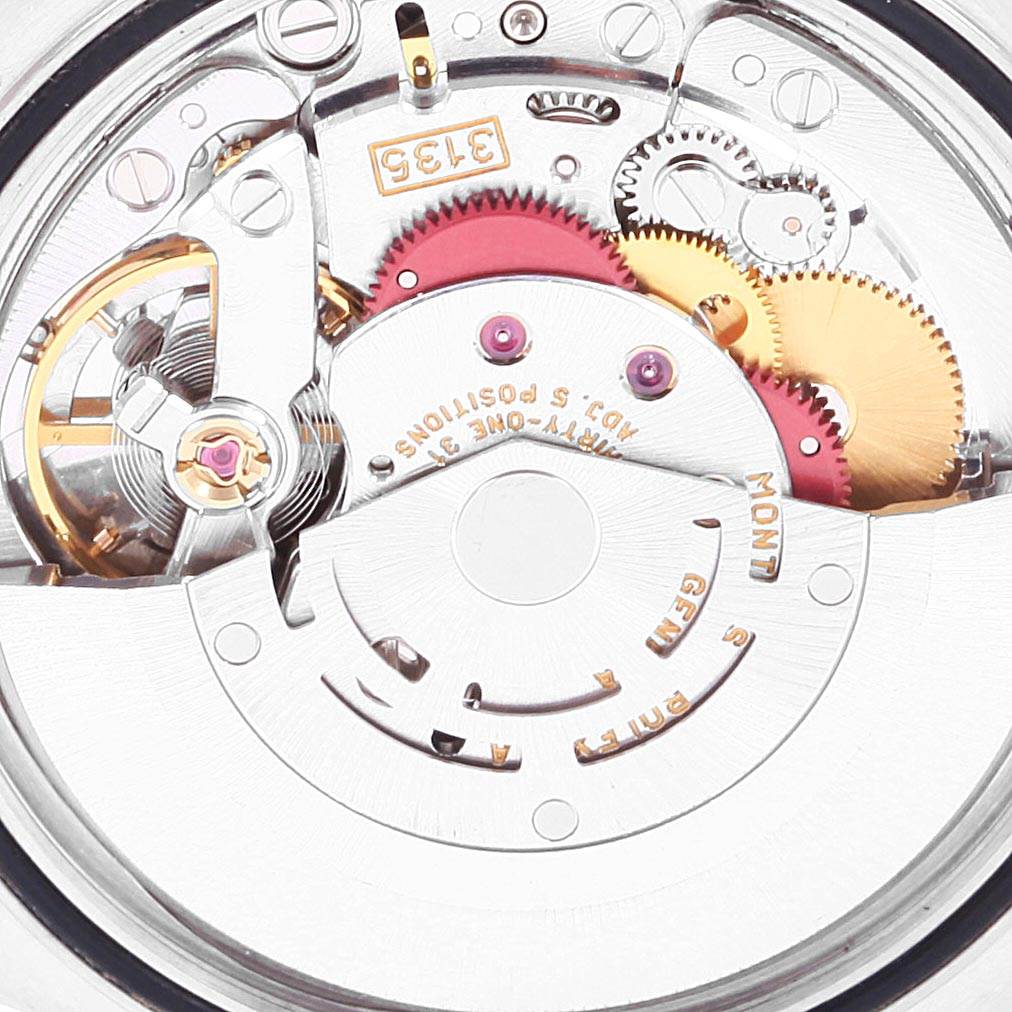 This image shows a close-up of the movement mechanism of the Rolex Datejust 16234 Men's Stainless Steel Blue Dial 16234 Men's Stainless Steel Blue Dial watch, highlighting gears and intricate components.