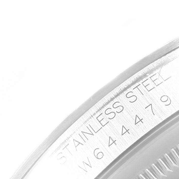 This image shows a close-up of the stainless steel bezel with the engraved serial number of a Rolex Datejust 16234 Men's Stainless Steel Blue Dial 16234 Men's Stainless Steel Blue Dial watch.
