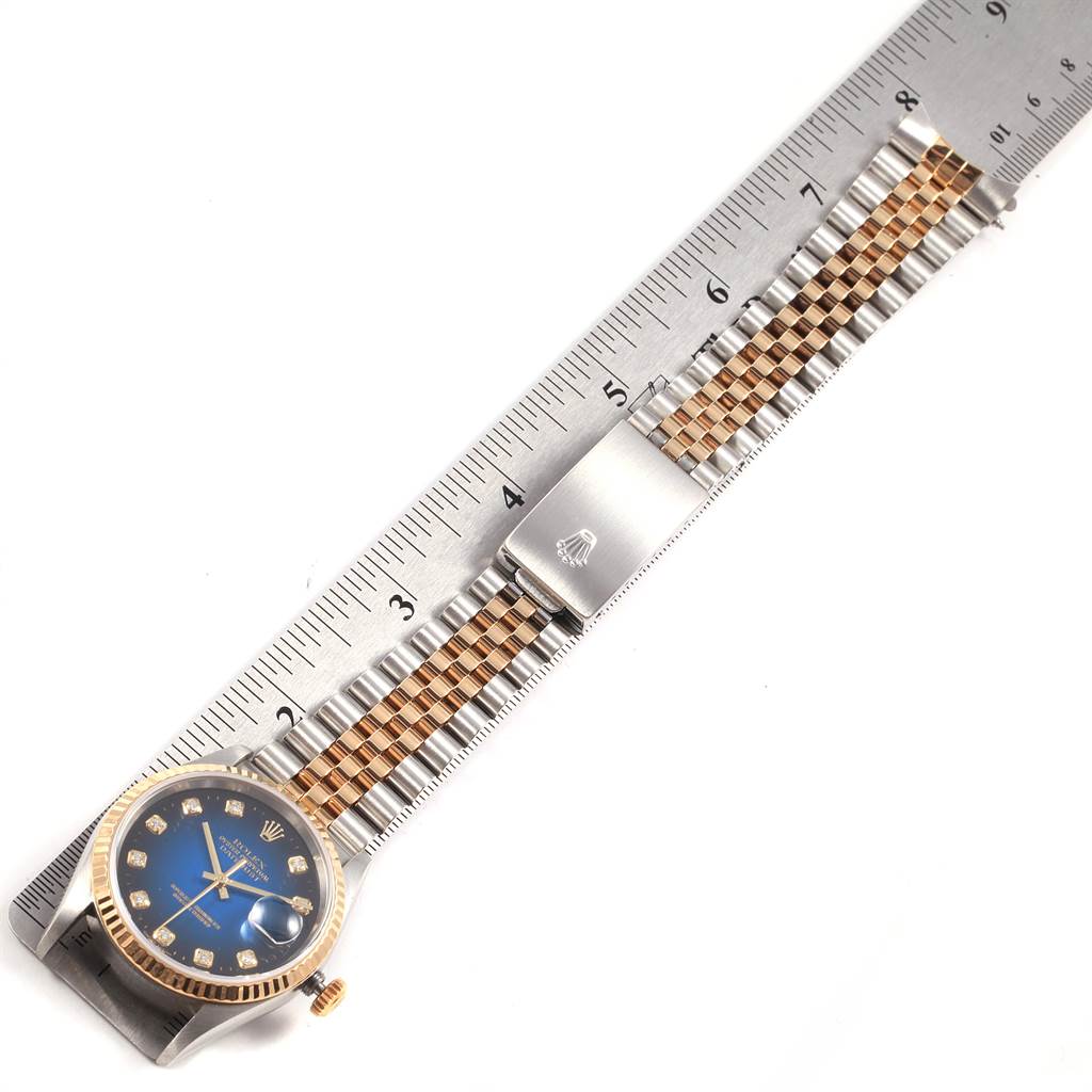 The image shows the face, bezel, and bracelet of a Rolex Datejust 16233 Men's Steel and Gold (two tone) Blue Dial 16233 Men's Steel and Gold (two tone) Blue Dial watch, aligned with a ruler for measurement.