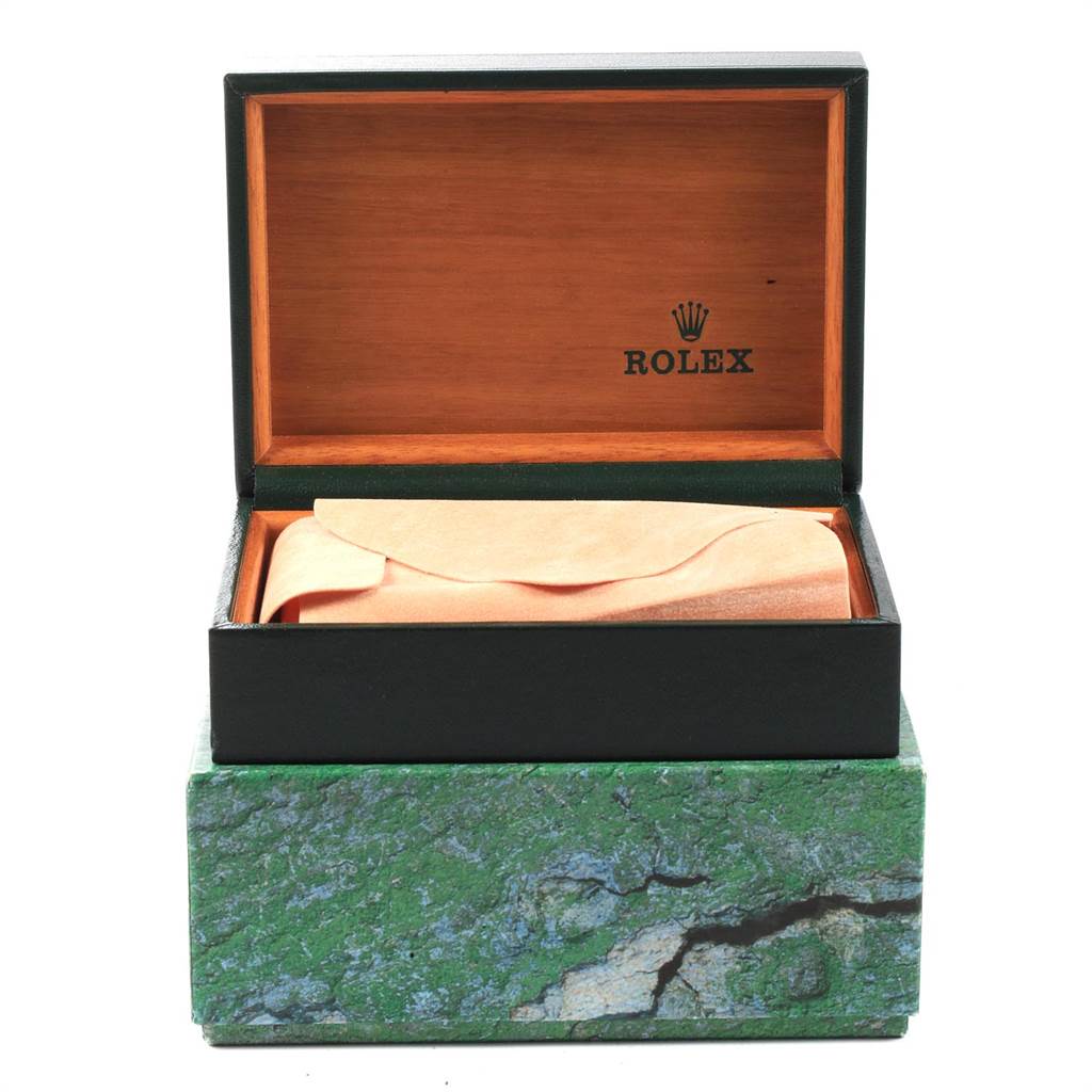The image shows an open Rolex watch box for the Datejust model with a green, marbled exterior and wooden interior.