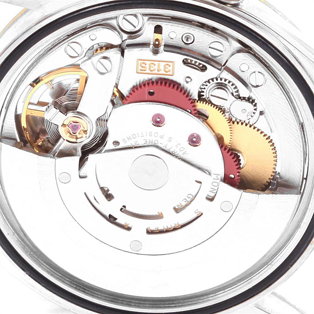 This is a macro shot focusing on the intricate internal mechanism of a Rolex Datejust 16233 Men's Steel and Gold (two tone) Blue Dial 16233 Men's Steel and Gold (two tone) Blue Dial watch, highlighting gears and movement parts.