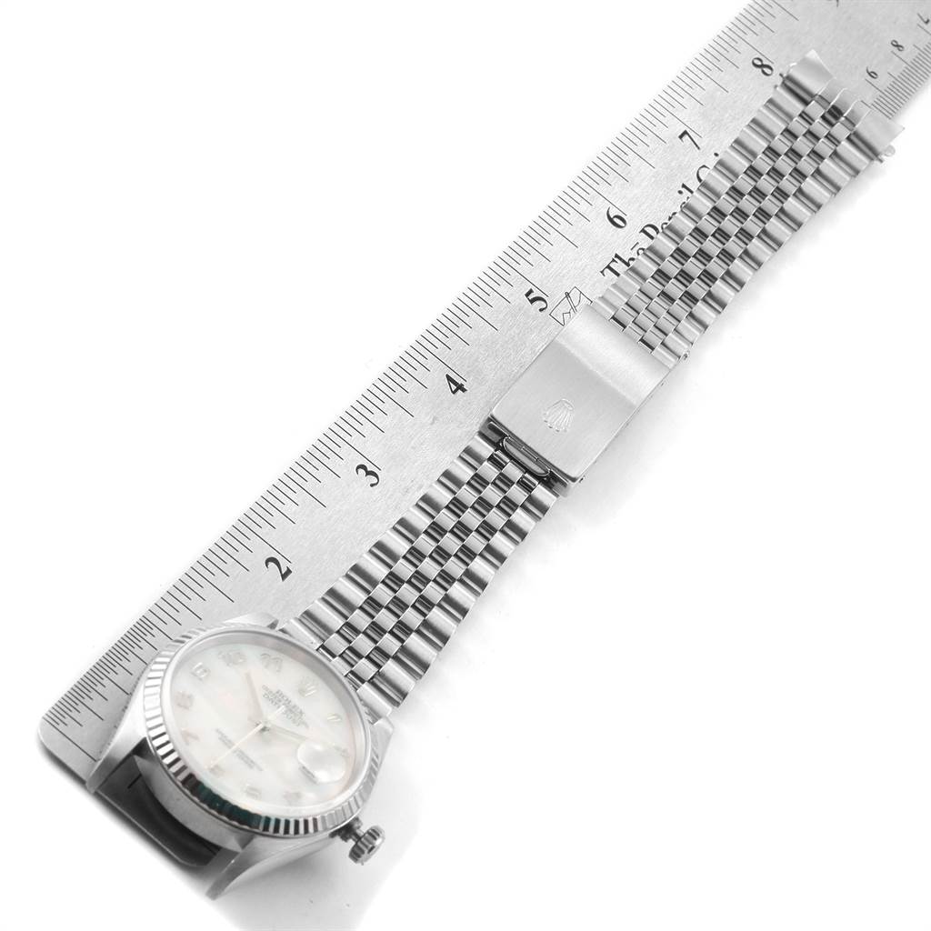 The image shows a Rolex Datejust 16234 Men's Stainless Steel Mother of Pearl Dial 16234 Men's Stainless Steel Mother of Pearl Dial watch laid flat at an angle, with its bracelet and clasp extended, next to a ruler for measurement.