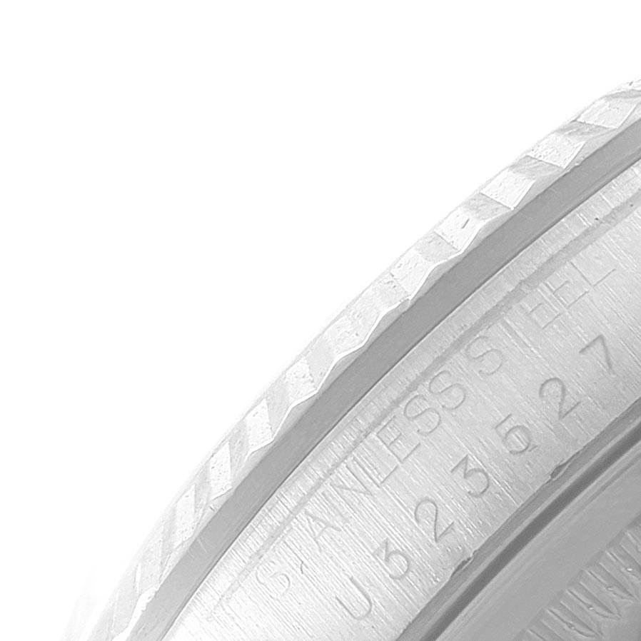 This close-up image shows the side of the bezel and part of the case of a Rolex Datejust 16234 Men's Stainless Steel Mother of Pearl Dial 16234 Men's Stainless Steel Mother of Pearl Dial watch with serial number markings.