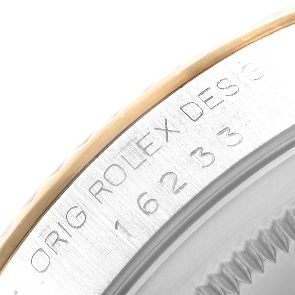 The image shows an angled close-up view of the bezel and model engraving of a Rolex Datejust 16233 Men's Steel and Gold (two tone) White Dial 16233 Men's Steel and Gold (two tone) White Dial watch.
