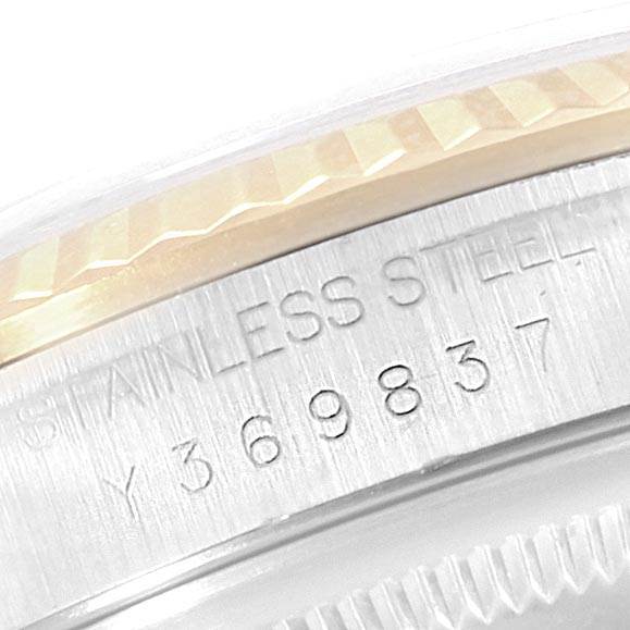 The image shows a close-up angle of the serial number and "STAINLESS STEEL" engraving on the case of a Rolex Datejust 16233 Men
s Steel and Gold (two tone) White Dial 16233 Men
s Steel and Gold (two tone) White Dial watch.