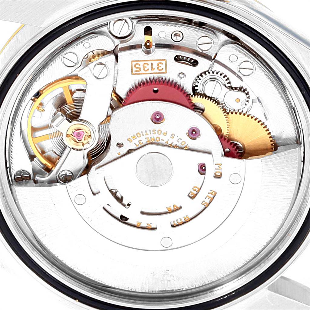 The image shows an angled close-up view of the movement mechanism inside a Rolex Datejust 16233 Men
s Steel and Gold (two tone) White Dial 16233 Men
s Steel and Gold (two tone) White Dial watch.