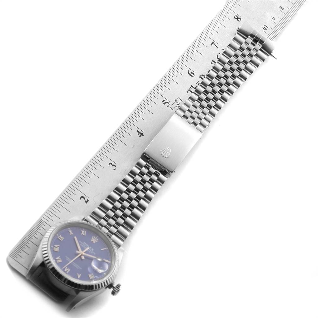 The image shows a Rolex Datejust 16234 Men's Stainless Steel Blue Dial 16234 Men's Stainless Steel Blue Dial model watch horizontal with a ruler, featuring its face, bezel, and bracelet.