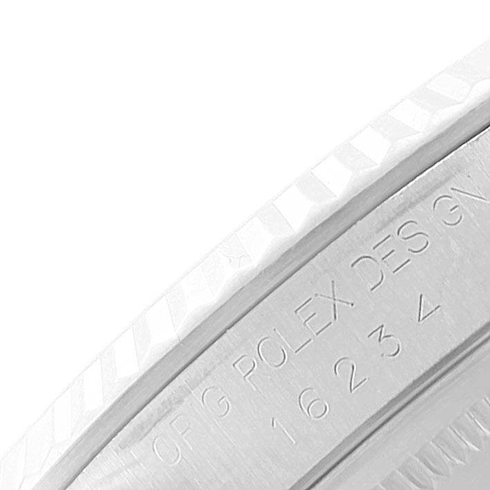 The image shows a close-up of the bezel and engraved inner ring of the Rolex Datejust 16234 Men's Stainless Steel Blue Dial 16234 Men's Stainless Steel Blue Dial watch.