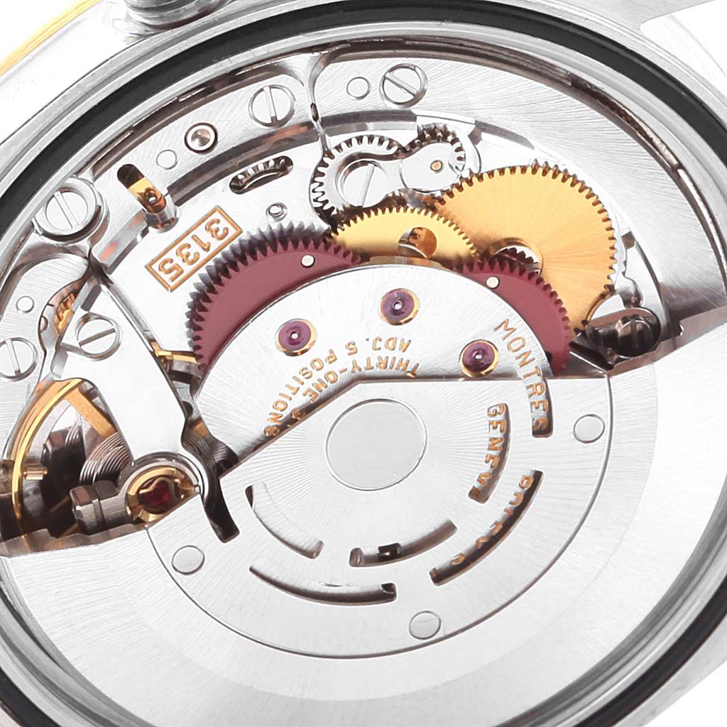 This image shows the internal mechanism of the Rolex Datejust 16233 Men's Steel and Gold (two tone) Silver Dial 16233 Men's Steel and Gold (two tone) Silver Dial watch, including gears and the rotor.