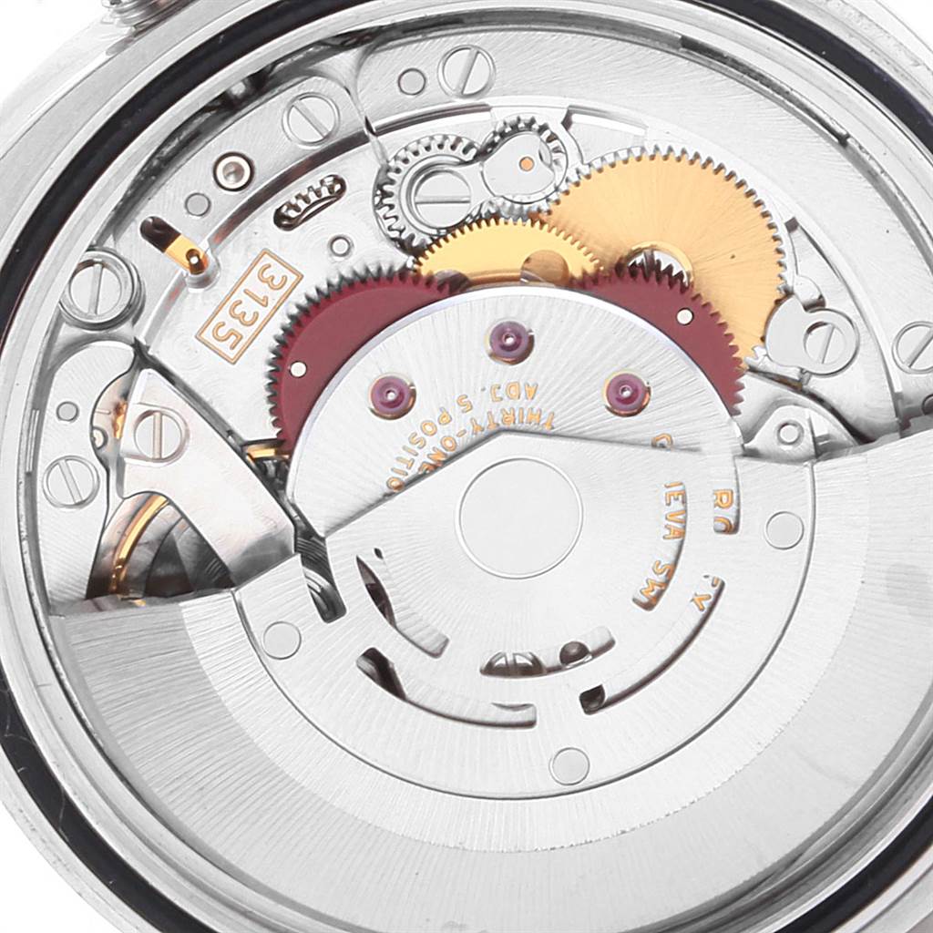 The image shows an internal view of the Rolex Datejust 116234 Men's Stainless Steel Black Dial 116234 Men's Stainless Steel Black Dial watch, highlighting its intricate gears and mechanical movement.