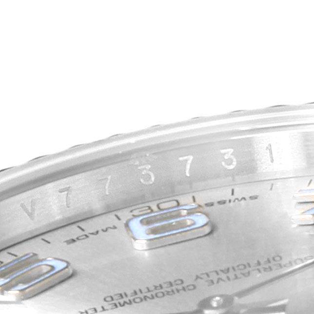 A partial close-up of the Rolex Datejust 116334 Men
s Stainless Steel Grey Dial 116334 Men
s Stainless Steel Grey Dial watch showing the engraved inner bezel and part of the dial with hour markers.