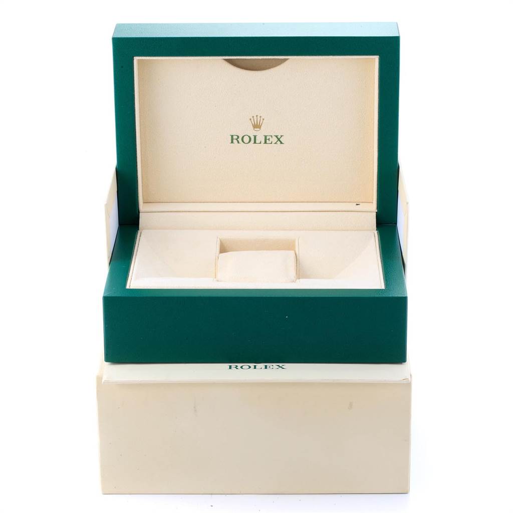 The image shows an open green and beige Rolex box, likely for a Datejust model, on top of an outer beige box.